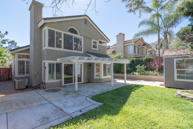 rear view of property with a patio, a yard, a pergola, stucco siding, and central air condition unit