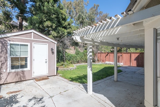 view of patio / terrace with an outdoor structure, fence, a pergola, and a shed