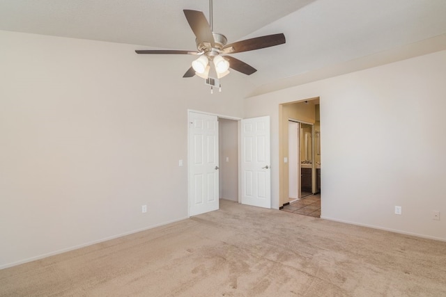 carpeted empty room featuring a ceiling fan, visible vents, and baseboards