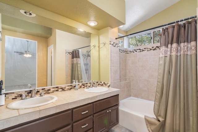 full bath with a sink, lofted ceiling, shower / tub combo with curtain, and double vanity