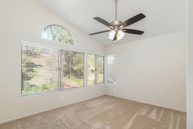 empty room featuring light colored carpet, ceiling fan, and high vaulted ceiling