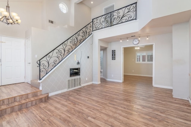 interior space with visible vents, stairway, baseboards, and wood finished floors