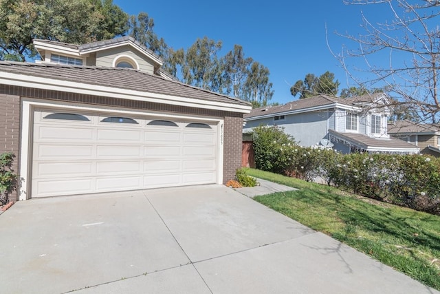 garage featuring concrete driveway