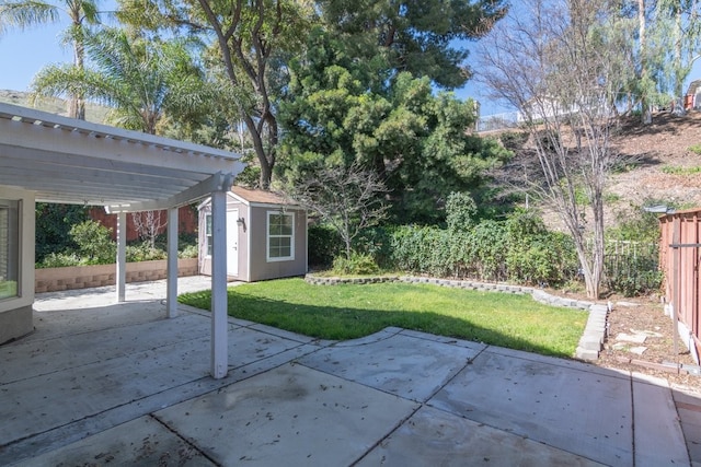 view of patio / terrace with a storage unit, a fenced backyard, a pergola, and an outdoor structure