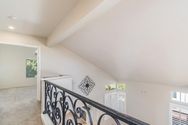 corridor featuring vaulted ceiling with beams, an upstairs landing, plenty of natural light, and carpet floors