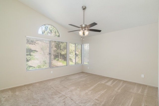 unfurnished room with high vaulted ceiling, light colored carpet, and a ceiling fan