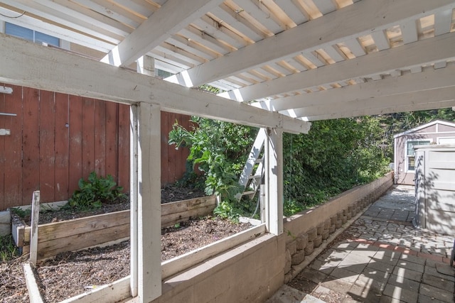 view of patio / terrace featuring a storage unit and an outdoor structure