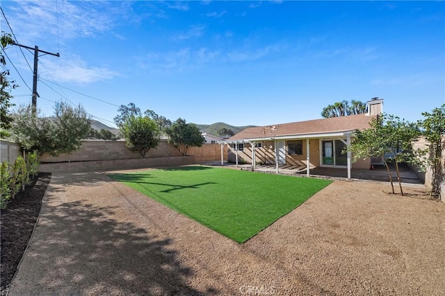 view of yard with a patio area and a fenced backyard