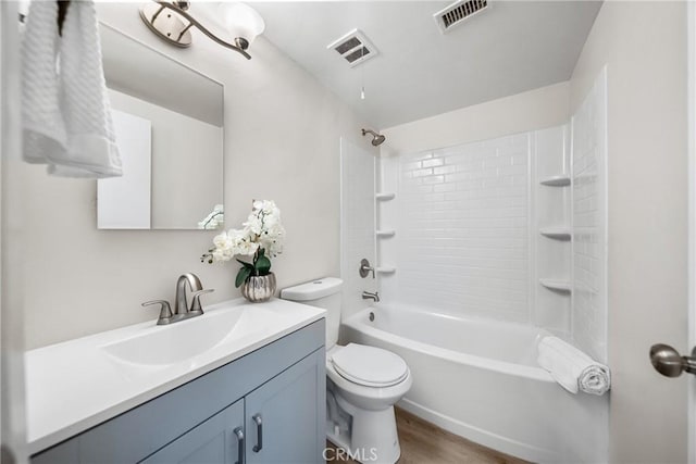 bathroom featuring vanity, toilet, wood finished floors, and visible vents