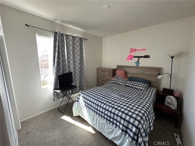 carpeted bedroom featuring baseboards