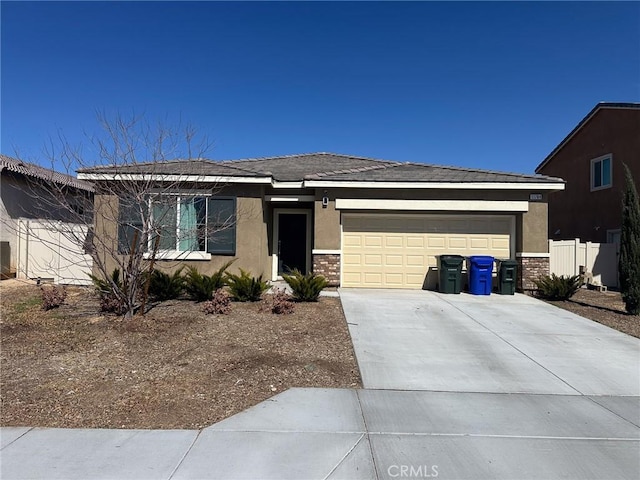 ranch-style house featuring concrete driveway, brick siding, a garage, and stucco siding