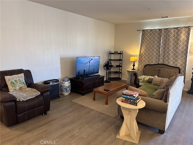 living room with visible vents and wood finished floors