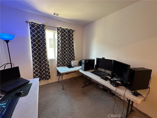 carpeted office with visible vents and baseboards