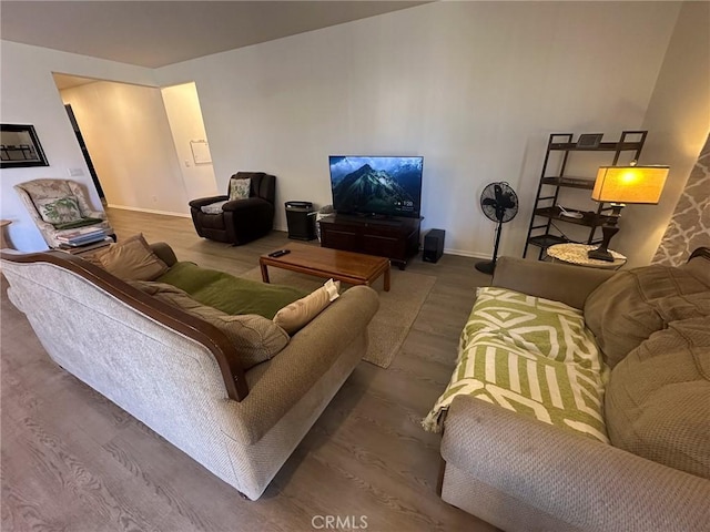 living room featuring wood finished floors and baseboards