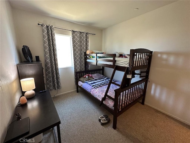 bedroom with baseboards and carpet