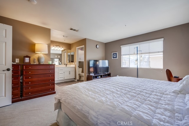 bedroom featuring visible vents, an inviting chandelier, connected bathroom, and carpet floors