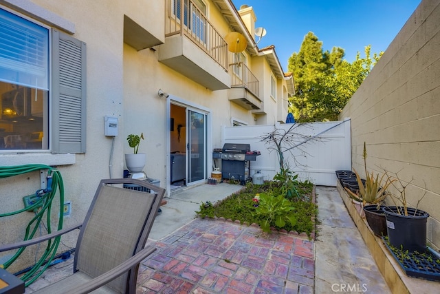 view of patio / terrace featuring a grill and fence