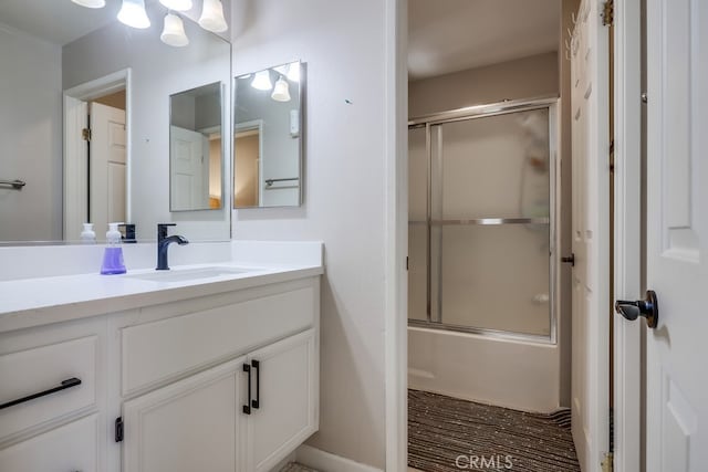 full bathroom featuring shower / bath combination with glass door and vanity