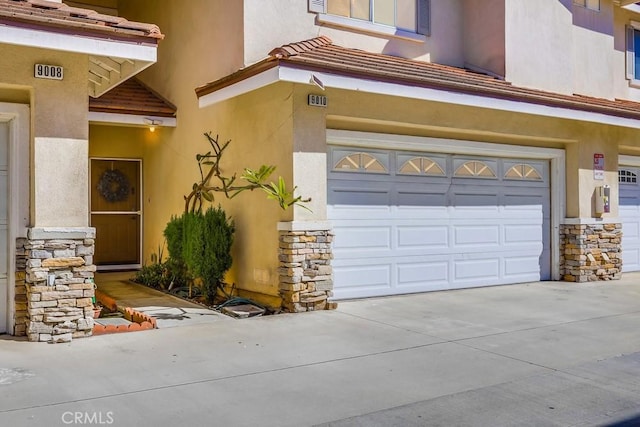 garage with driveway and visible vents