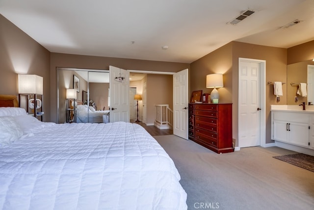 bedroom featuring visible vents, baseboards, and light colored carpet
