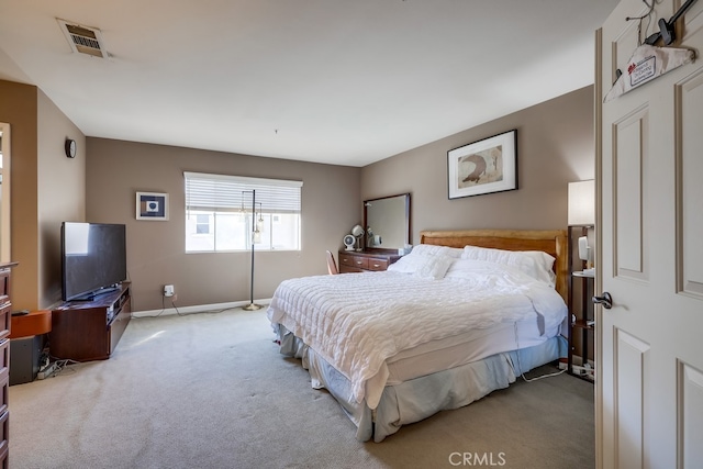 carpeted bedroom with visible vents and baseboards