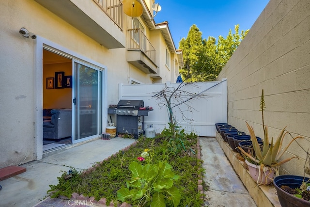 exterior space featuring fence and a grill