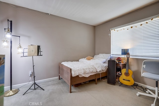 carpeted bedroom featuring baseboards