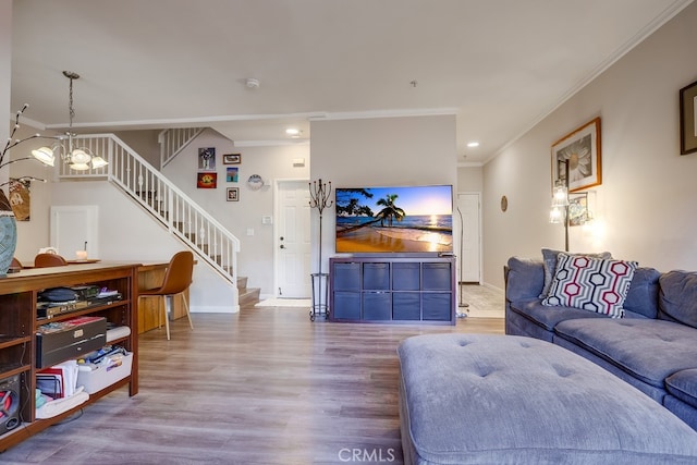 living room with ornamental molding, baseboards, stairway, and wood finished floors