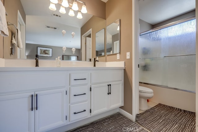 bathroom featuring visible vents, toilet, double vanity, and a chandelier