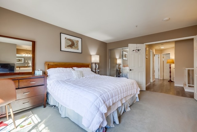bedroom with light carpet and a closet