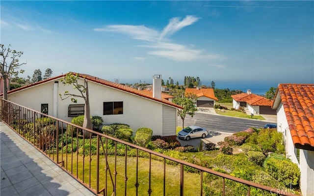 view of side of property featuring a tiled roof