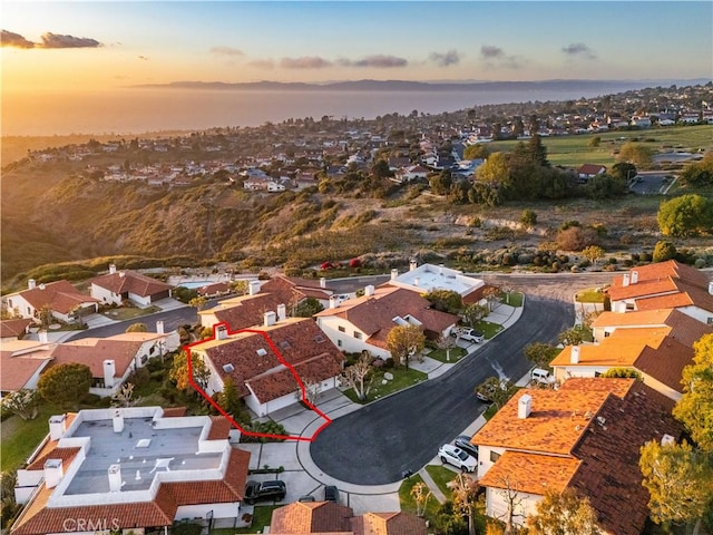 aerial view at dusk featuring a residential view