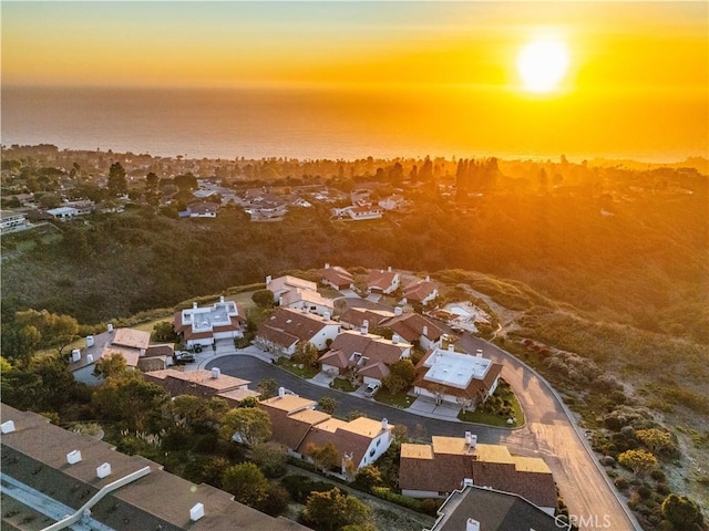 aerial view at dusk featuring a residential view