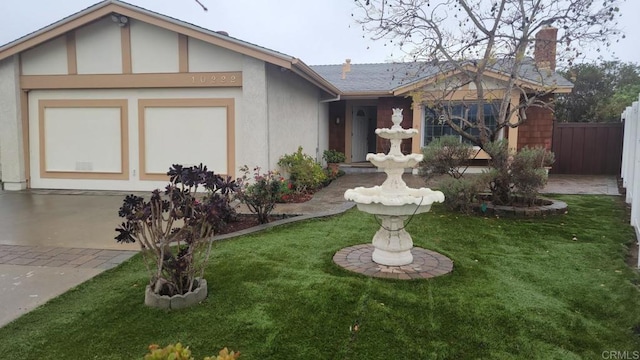 view of front of house with stucco siding, a chimney, a front lawn, and fence