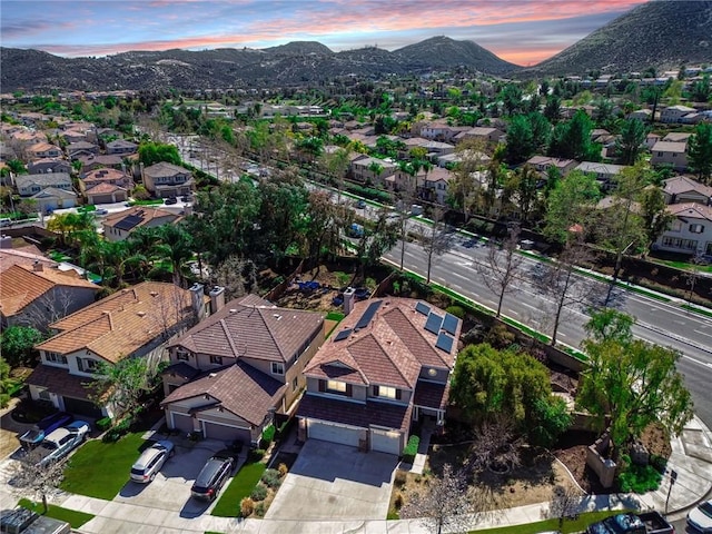 aerial view at dusk featuring a residential view and a mountain view