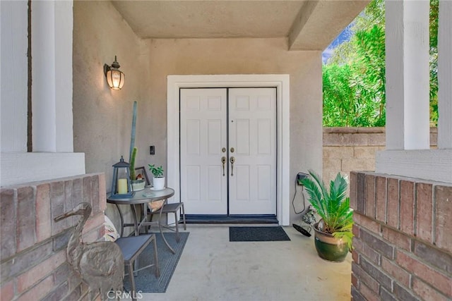 doorway to property featuring stucco siding