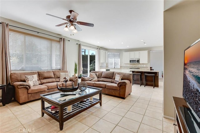 living area with light tile patterned floors, recessed lighting, and a ceiling fan