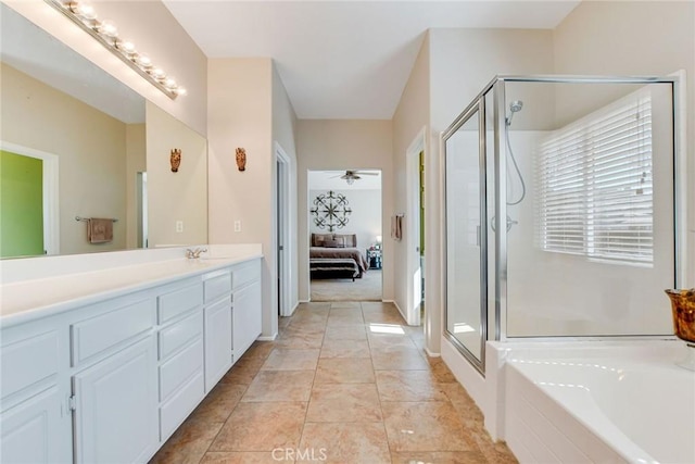 ensuite bathroom featuring vanity, a bath, a stall shower, and connected bathroom