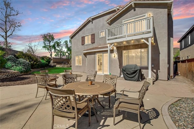 view of patio / terrace featuring area for grilling, a balcony, outdoor dining area, and fence