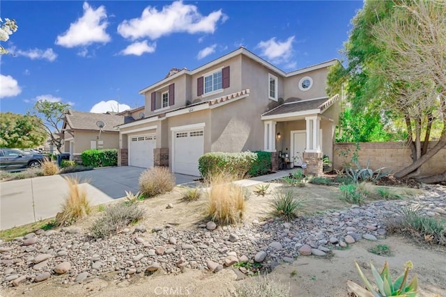 view of front of house featuring stucco siding, fence, concrete driveway, a garage, and a tiled roof