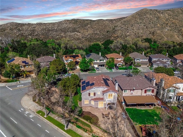 aerial view at dusk with a mountain view and a residential view