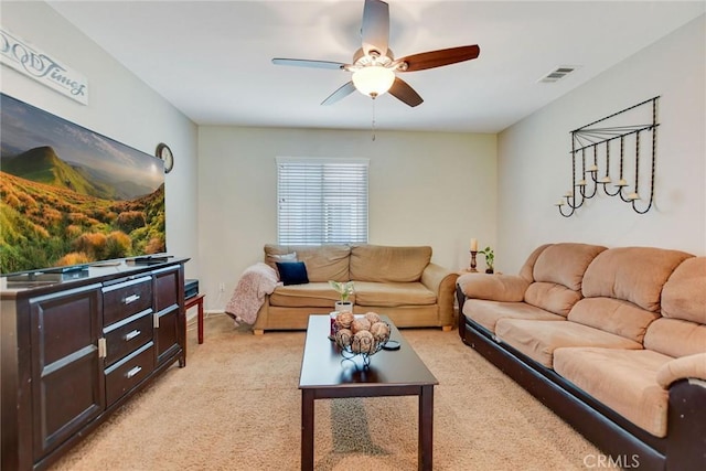 living room featuring visible vents, light carpet, and a ceiling fan