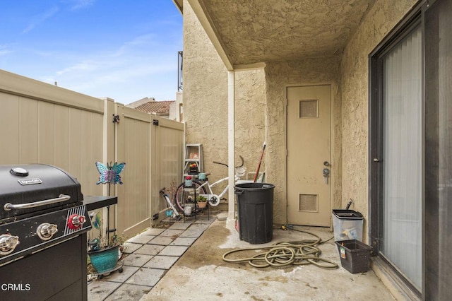 view of patio with grilling area and fence