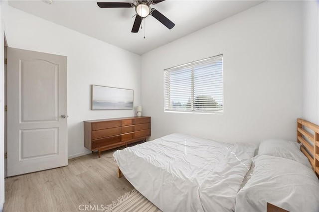 bedroom featuring light wood-type flooring and a ceiling fan