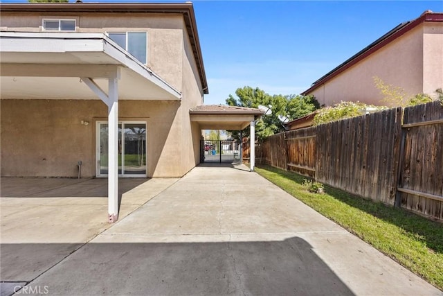 exterior space featuring stucco siding, a patio area, and fence