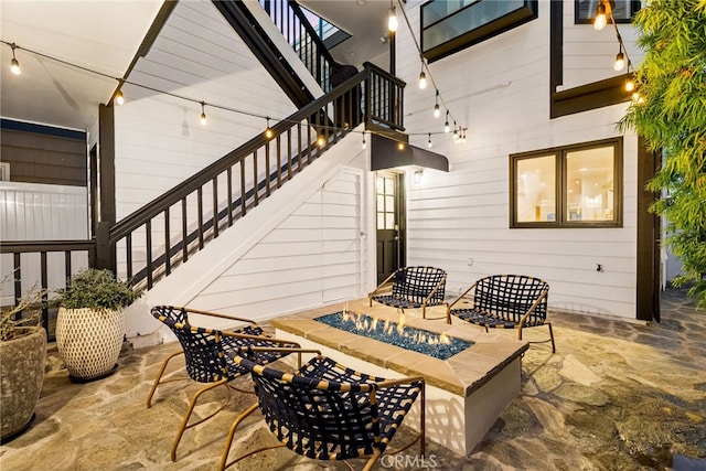 view of patio / terrace featuring a fire pit and stairs