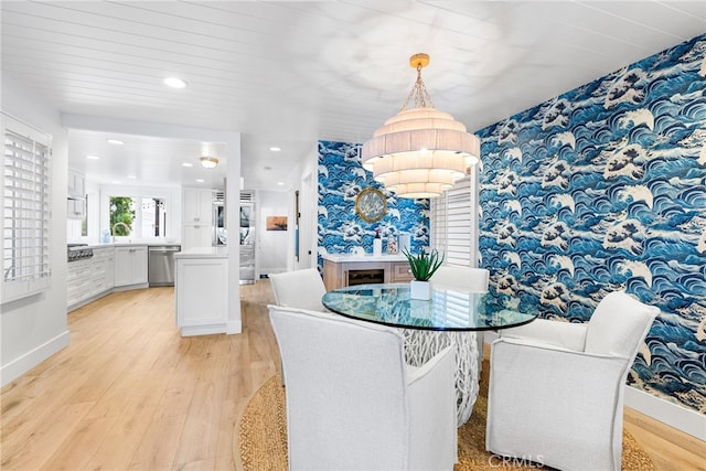 dining area with wallpapered walls, recessed lighting, light wood-type flooring, and baseboards