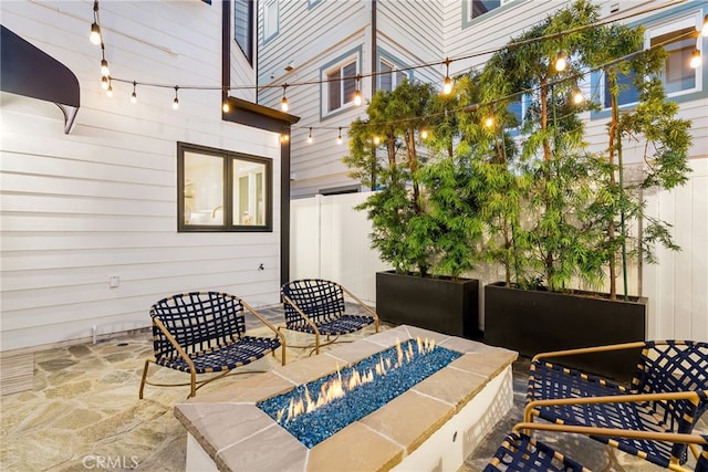 view of patio featuring a fire pit and fence