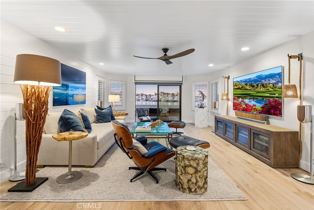 living room with a wealth of natural light, recessed lighting, a ceiling fan, and wood finished floors