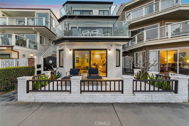 rear view of property featuring a fenced front yard